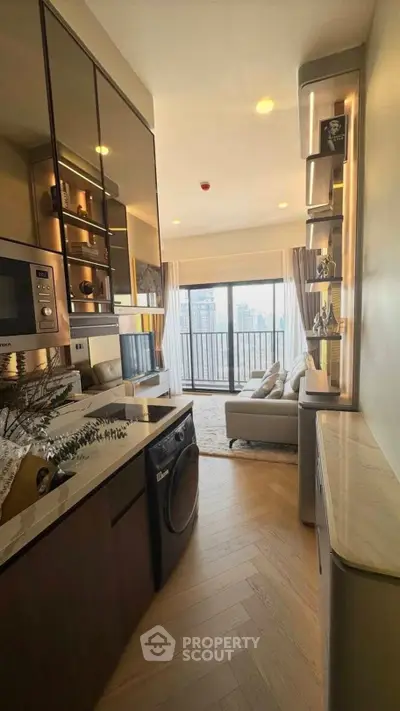 Modern apartment with open kitchen and living room, featuring a balcony with city view.