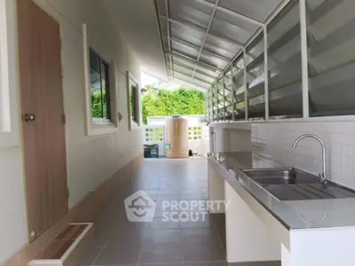 Modern outdoor kitchen with sleek countertops and ample natural light