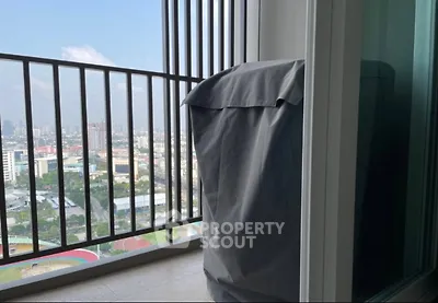 High-rise balcony with city view and covered appliance