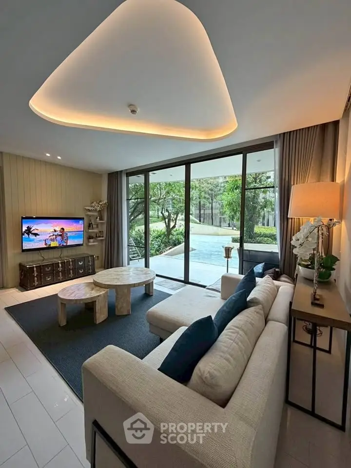 Luxurious living room with pool view and modern decor