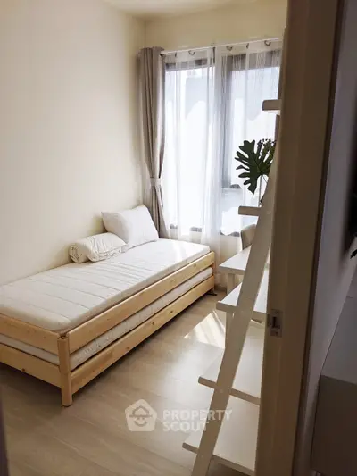 Cozy minimalist bedroom with natural light and wooden furniture