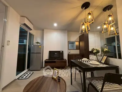 Modern living room with stylish decor and open layout, featuring elegant lighting and a cozy atmosphere.