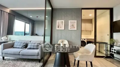 Modern living room with glass partition and cozy dining area in stylish apartment.