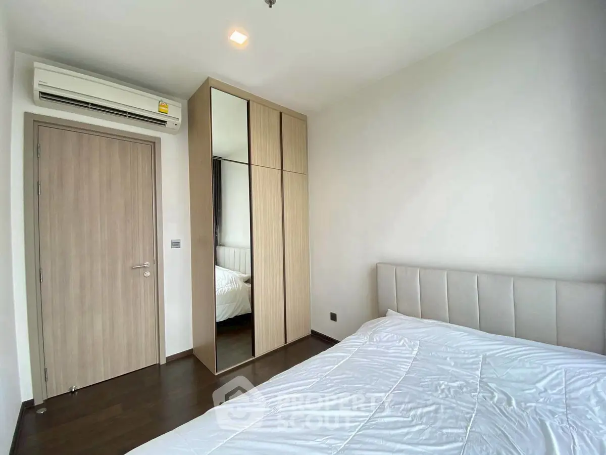 Modern bedroom with sleek wardrobe and air conditioning, perfect for comfort and style.