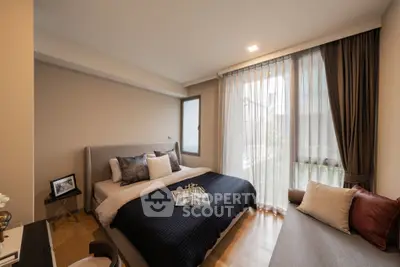 Luxurious bedroom with elegant decor and natural light, featuring a cozy bed and stylish furnishings.