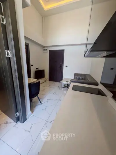 Modern kitchen with sleek design and marble flooring in a contemporary apartment.