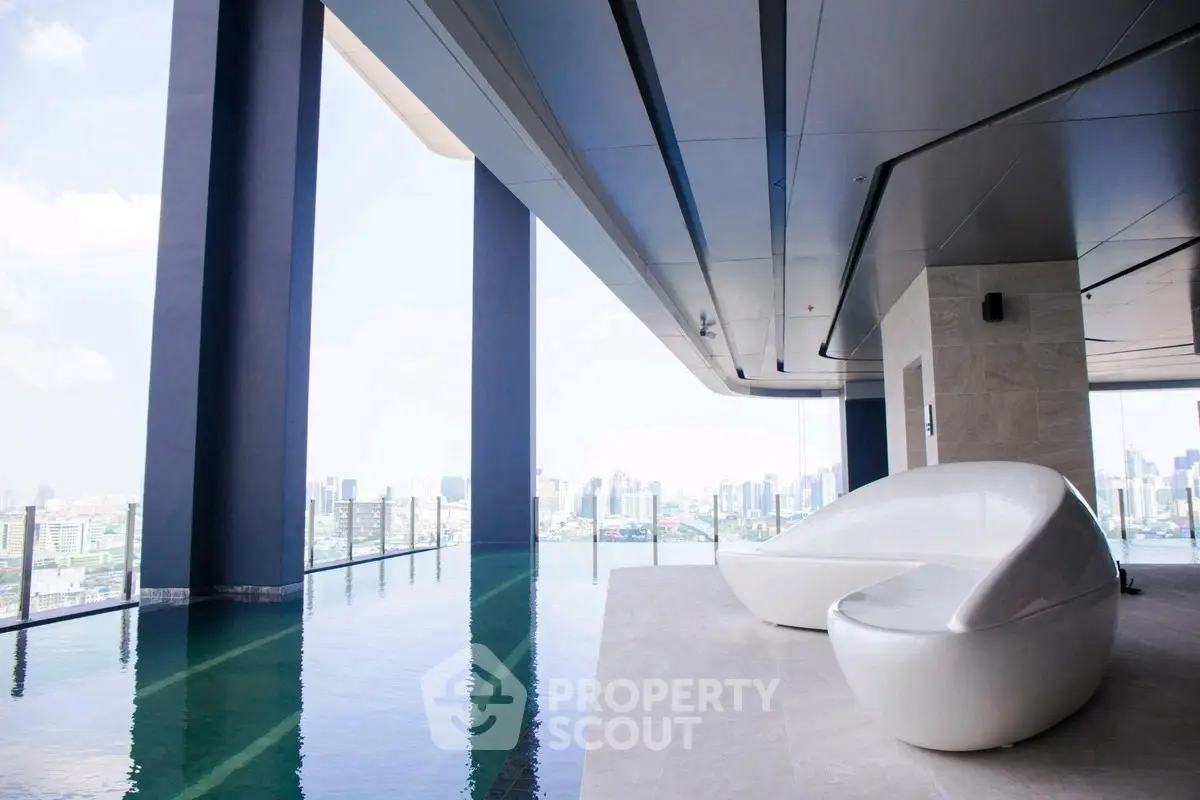 Luxurious rooftop pool with stunning city views and modern seating area.