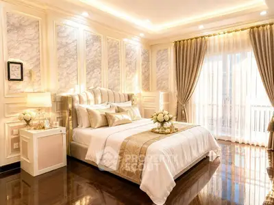 Luxurious bedroom with elegant decor and natural light, featuring plush bedding and sophisticated design.