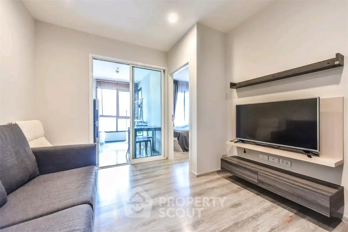 Modern living room with sleek furniture and TV, featuring a bright and airy ambiance.