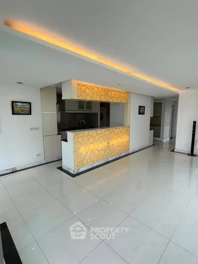 Spacious modern living room with stylish open kitchen and elegant lighting
