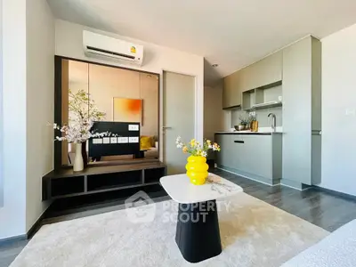 Modern living room with sleek kitchen and stylish decor