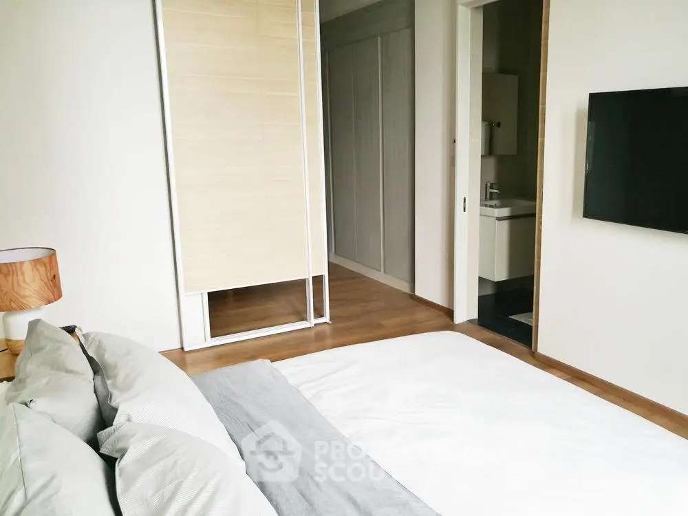 Modern bedroom with minimalist decor and ensuite bathroom
