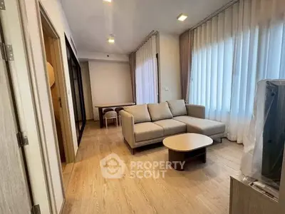 Modern living room with cozy sofa and natural light, perfect for relaxation and entertaining.