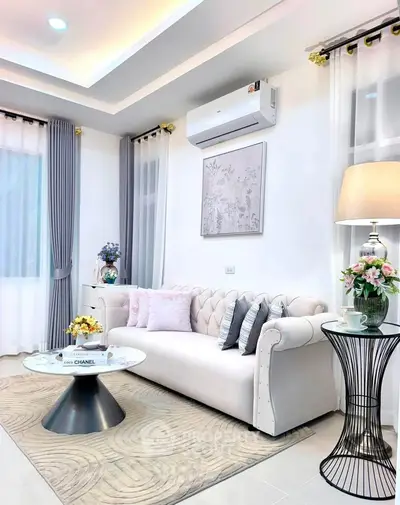 Elegant living room with modern decor, featuring a plush sofa, stylish coffee table, and ambient lighting.