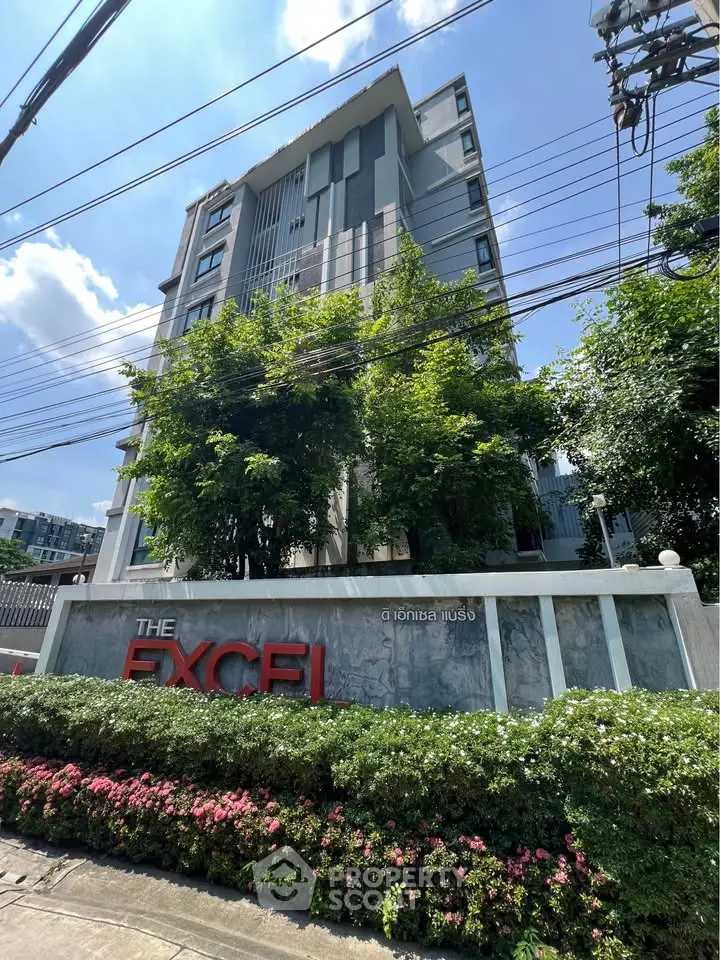 Modern residential building with lush greenery and clear blue sky