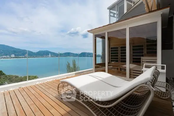 Luxurious balcony with stunning ocean view and modern lounge chairs
