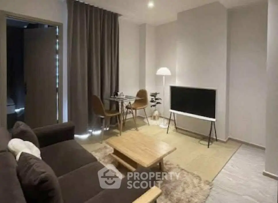 Modern living room with cozy seating and sleek TV setup