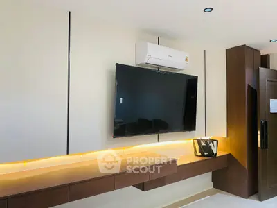 Modern living room with sleek TV setup and stylish lighting
