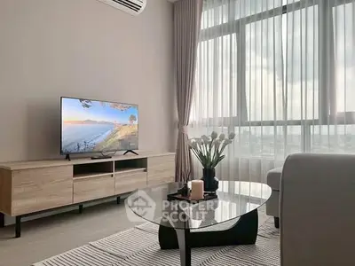 Modern living room with large window, stylish furniture, and natural light.
