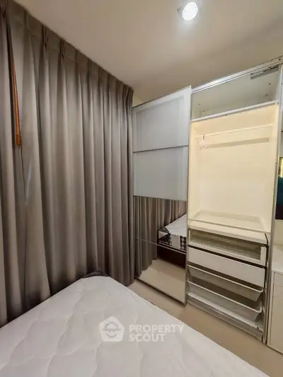 Cozy bedroom with built-in wardrobe and elegant curtains