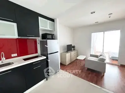 Modern open-layout kitchen and living room with sleek design and natural light.