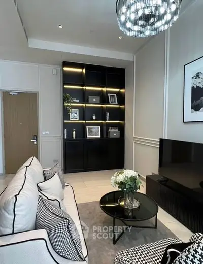 Elegant living room with modern decor, featuring a stylish black shelving unit and cozy seating area.