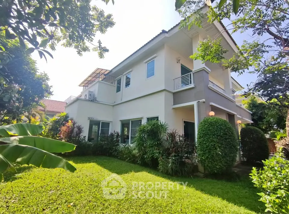 Charming two-story house with lush garden and modern design