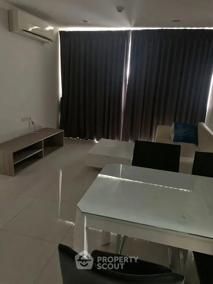 Modern living room with sleek furniture and large windows, perfect for urban living.