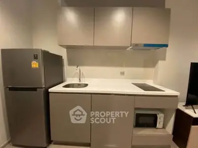 Modern compact kitchen with sleek cabinets and stainless steel appliances