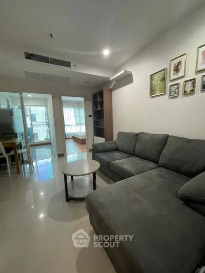 Spacious living room with modern sofa and stylish decor in a contemporary apartment.