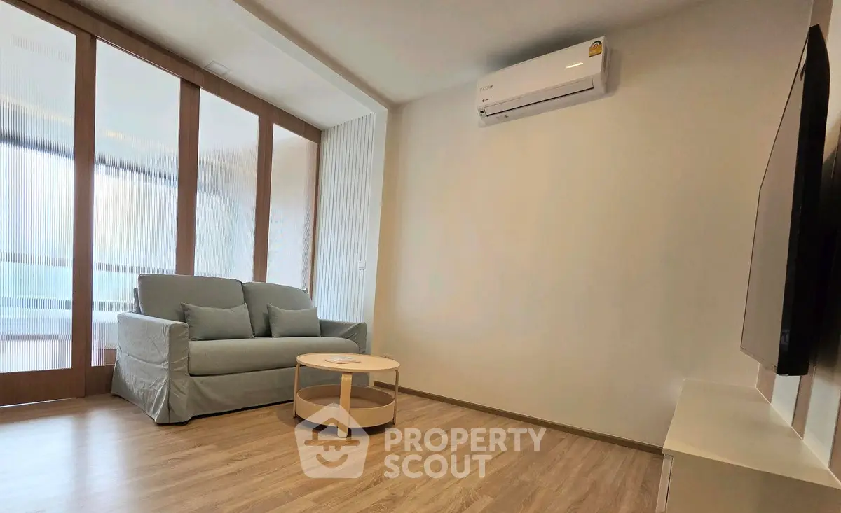 Modern living room with air conditioning and stylish furniture