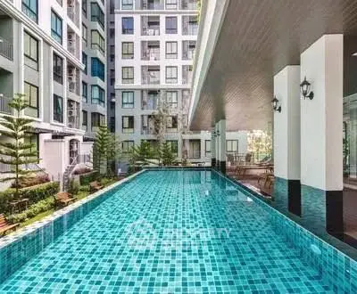 Luxurious condominium with a stunning outdoor pool and modern architecture.