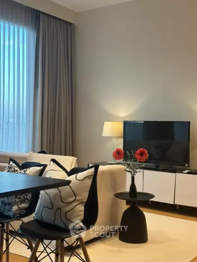 Modern living room with stylish decor, cozy seating, and a sleek TV setup.