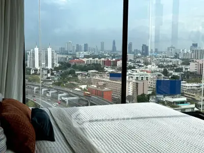 Luxurious bedroom with stunning city skyline view from large window