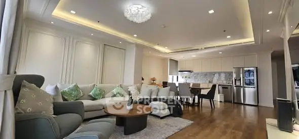Luxurious open-plan living room with elegant decor and modern kitchen, perfect for entertaining.