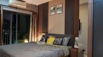 Modern bedroom with stylish decor and city view, featuring cozy bedding and elegant lighting.