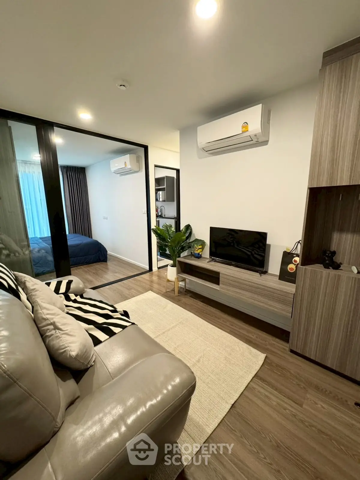 Modern living room with cozy seating and sleek entertainment center