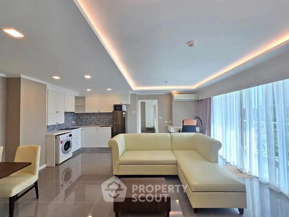 Spacious modern living room with open kitchen and elegant furnishings