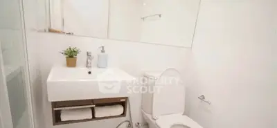 Modern minimalist bathroom with white fixtures and sleek design