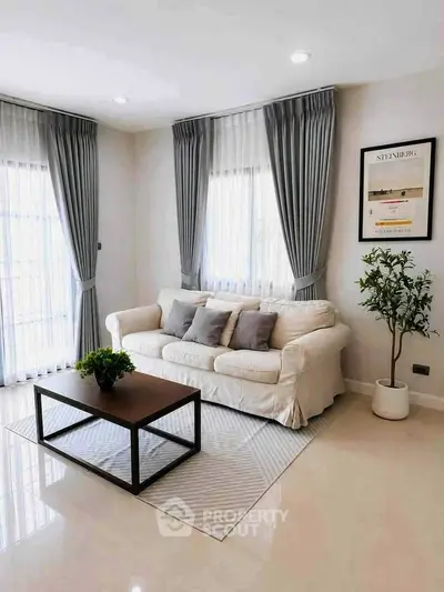 Elegant living room with cozy sofa, stylish curtains, and modern decor in a bright, inviting space.