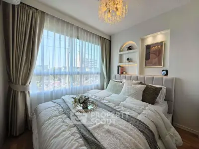 Luxurious bedroom with elegant decor and large window offering stunning city views.