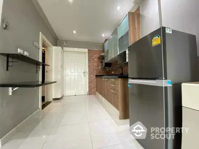 Modern kitchen with sleek cabinets and stainless steel fridge in a stylish apartment