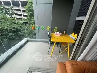 Charming balcony with colorful furniture and lush greenery view, perfect for relaxation and outdoor dining.
