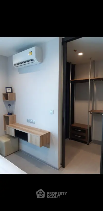 Modern bedroom with walk-in closet and air conditioning unit