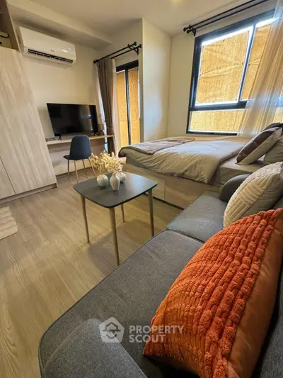 Modern studio apartment with cozy living area and stylish decor