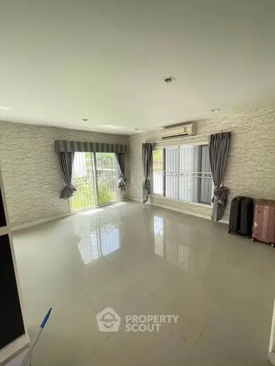 Spacious living room with large windows and modern decor