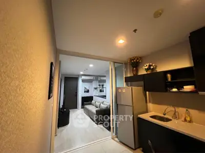 Modern open-layout kitchen with sleek cabinets and cozy living room view