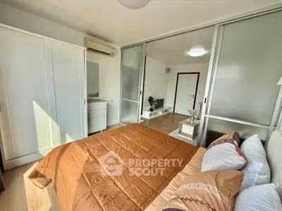 Modern bedroom with sliding doors and cozy decor in a stylish apartment.