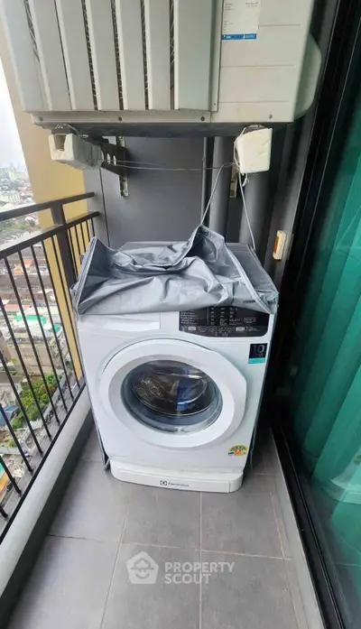 Modern balcony with washing machine and city view, perfect for urban living convenience.