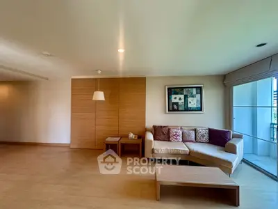 Spacious living room with modern decor and large windows